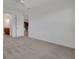 Spacious carpeted bedroom with an open doorway view to a bathroom and a chair in the background at 7947 Lake James Blvd, Lakeland, FL 33810