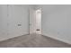 Carpeted bedroom with double doors and laundry room access at 7947 Lake James Blvd, Lakeland, FL 33810