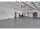Spacious two car garage with neutral walls and floors, storage, and utility area at 7947 Lake James Blvd, Lakeland, FL 33810