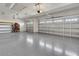 Spacious two car garage with neutral walls and floors and two doors at 7947 Lake James Blvd, Lakeland, FL 33810