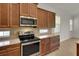 Updated kitchen featuring stainless steel appliances, granite countertops, and custom cabinetry at 7947 Lake James Blvd, Lakeland, FL 33810
