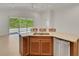 Modern kitchen island with a stainless steel dishwasher and space for seating, overlooking a patio at 7947 Lake James Blvd, Lakeland, FL 33810