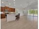 Open-concept kitchen boasts stainless steel appliances and a breakfast bar with seating at 7947 Lake James Blvd, Lakeland, FL 33810