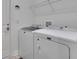 Bright laundry room featuring modern washer and dryer and ample shelving at 7947 Lake James Blvd, Lakeland, FL 33810