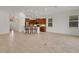 Spacious living area open to the kitchen with bright lighting and neutral tile flooring at 7947 Lake James Blvd, Lakeland, FL 33810