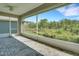 Screened patio features brick pavers, peaceful backyard views, and ceiling fan at 7947 Lake James Blvd, Lakeland, FL 33810