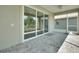 Spacious screened patio with brick pavers and sliding glass doors that offer access to interior at 7947 Lake James Blvd, Lakeland, FL 33810