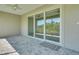 Screened patio featuring sliding glass doors with peaceful backyard views at 7947 Lake James Blvd, Lakeland, FL 33810