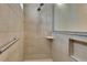 Shower features neutral tiles, niche, and grab bar, combining style and functionality at 7947 Lake James Blvd, Lakeland, FL 33810