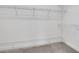 Spacious walk-in closet with multiple levels of white wire shelving and gray carpet at 7947 Lake James Blvd, Lakeland, FL 33810