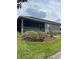 A view of the backyard with the house, showing mulch beds and green grass at 914 Christina Chase Dr # Drive, Lakeland, FL 33813