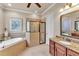 This spacious bathroom has a corner soaking tub, walk-in shower with glass, and a vanity with granite countertop at 914 Christina Chase Dr # Drive, Lakeland, FL 33813
