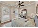 A bedroom with a plush comforter, two shuttered windows, and a wood dresser with a decorative mirror at 914 Christina Chase Dr # Drive, Lakeland, FL 33813
