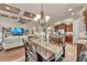 Dining area adjacent to kitchen boasts coffered ceilings and modern chandelier, blending seamlessly with the living space at 914 Christina Chase Dr # Drive, Lakeland, FL 33813