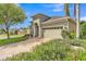 Stunning house exterior with a lush lawn and paver driveway leading to a two-car garage at 914 Christina Chase Dr # Drive, Lakeland, FL 33813