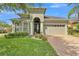 Charming single-story home featuring a well-manicured lawn and a welcoming arched entryway at 914 Christina Chase Dr # Drive, Lakeland, FL 33813