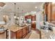 Spacious kitchen features a center island with granite counters, wood cabinets, and stainless appliances at 914 Christina Chase Dr # Drive, Lakeland, FL 33813