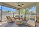 Screened-in patio with comfortable seating, ceiling fan, and tiled flooring at 914 Christina Chase Dr # Drive, Lakeland, FL 33813