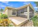 A cozy screened patio area with a brick base and tropical landscaping, perfect for outdoor relaxation at 914 Christina Chase Dr # Drive, Lakeland, FL 33813