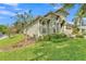 Landscaped side view of the home featuring a lush lawn, garden, and charming architectural details at 914 Christina Chase Dr # Drive, Lakeland, FL 33813