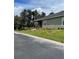 Side view of the house with a well-manicured lawn and landscaping at 914 Christina Chase Dr # Drive, Lakeland, FL 33813