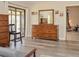 A bright bedroom features wood floors, dresser, sliding glass doors, and natural light at 3960 W Cypress Lndg, Winter Haven, FL 33884