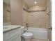 Bright bathroom featuring a shower-over-tub, tiled walls, and a granite-topped vanity at 1013 Rhodes S Rd, Haines City, FL 33844