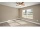 This bedroom features neutral carpet, a window, and a ceiling fan at 1013 Rhodes S Rd, Haines City, FL 33844