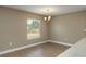 Dining room features hardwood floors, a modern light fixture, and a large window at 1013 Rhodes S Rd, Haines City, FL 33844