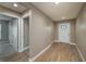 Inviting entryway featuring wood-look flooring, neutral walls, and a bright white front door with decorative glass at 1013 Rhodes S Rd, Haines City, FL 33844