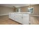 Large kitchen island with white cabinetry, stone countertops, and ample storage space at 1013 Rhodes S Rd, Haines City, FL 33844