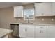 Kitchen with stainless steel appliances, stone counters, and white cabinetry at 1013 Rhodes S Rd, Haines City, FL 33844