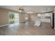 Open living space with wood-look floors, abundant natural light, and an island kitchen at 1013 Rhodes S Rd, Haines City, FL 33844