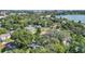 Aerial view of homes near the lake, with lush greenery and mature trees at 1028 W Marjorie St, Lakeland, FL 33815
