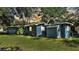 Exterior shot displaying a quaint backyard with a charming blue home at 1028 W Marjorie St, Lakeland, FL 33815