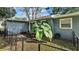 Cozy fenced backyard featuring a sliding glass door and mature trees, offering privacy and shade at 1028 W Marjorie St, Lakeland, FL 33815