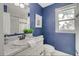 Beautiful blue bathroom featuring a marble vanity, a mirror, and a window at 1028 W Marjorie St, Lakeland, FL 33815