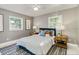 Bedroom featuring a large window, wood side tables, and a comfortable bed at 1028 W Marjorie St, Lakeland, FL 33815