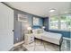 This beautiful bedroom features natural lighting from the windows, neutral walls, and minimalist decor at 1028 W Marjorie St, Lakeland, FL 33815