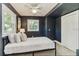 Comfortable bedroom featuring two windows, a ceiling fan, a closet, and neutral decor at 1028 W Marjorie St, Lakeland, FL 33815