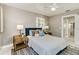 Bedroom with lamps, neutral gray walls, and bright windows with a view to the outdoors at 1028 W Marjorie St, Lakeland, FL 33815
