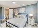 Charming bedroom features an accent wall, plush rug, and adjacent bathroom at 1028 W Marjorie St, Lakeland, FL 33815