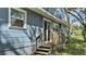Exterior view of blue home with wooden deck and landscaped yard at 1028 W Marjorie St, Lakeland, FL 33815