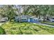 Well-maintained home with a lush front yard and mature trees at 1028 W Marjorie St, Lakeland, FL 33815