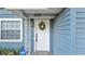 Inviting front door with decorative wreath and sidelight window, enhancing curb appeal at 1028 W Marjorie St, Lakeland, FL 33815