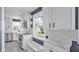 Bright kitchen features white cabinets, marble countertops and stainless steel appliances at 1028 W Marjorie St, Lakeland, FL 33815