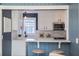 Bright kitchen features white cabinets, marble countertops and stainless steel appliances at 1028 W Marjorie St, Lakeland, FL 33815