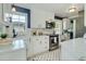 Bright kitchen features white cabinets, marble countertops and stainless steel appliances at 1028 W Marjorie St, Lakeland, FL 33815
