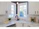 Bright kitchen features white cabinets, marble countertops and stainless steel appliances at 1028 W Marjorie St, Lakeland, FL 33815