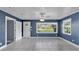 Bright living room with tiled floors, windows, and a white front door at 1028 W Marjorie St, Lakeland, FL 33815
